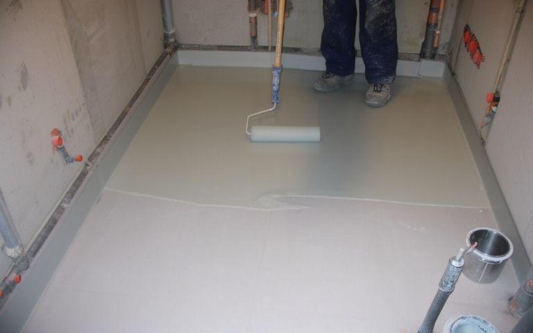 Polyurethane waterproofing membrane being applied to a bathroom floor